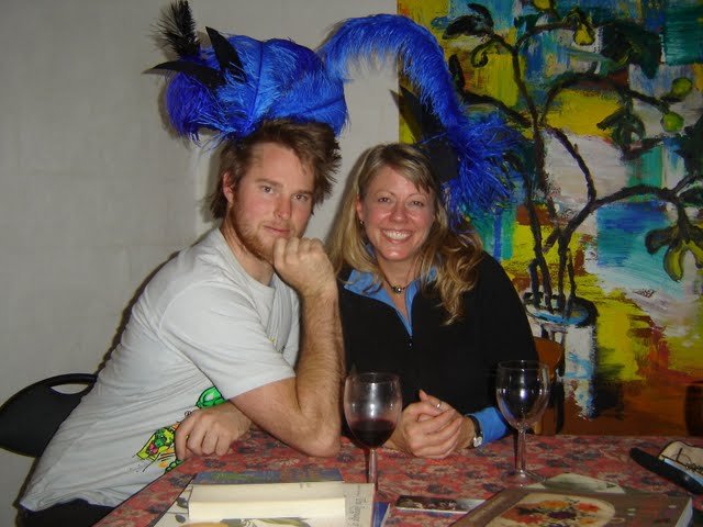 New Zealand artist Dave Beazley has a laugh at a La Muse book swap with American writer Cindy Willis, both wearing Andrea Simper burlesque creations made at La Muse