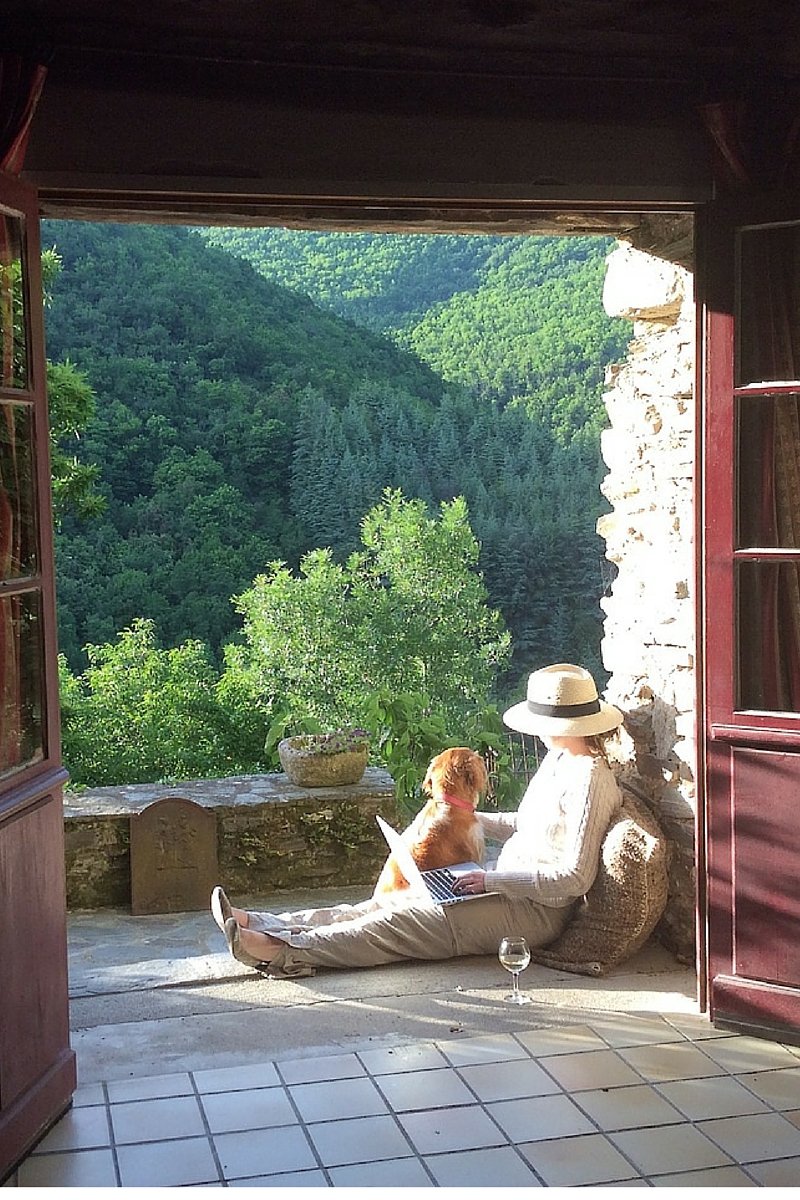 Writer Tara Button on retreat sitting in front of the library at La Muse artists and writers retreat